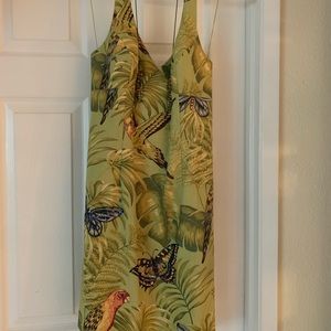 Green dress with tropical leaves and butterflies. Comes with a beaded necklace.